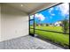 Screened patio with paver floor and backyard view at 6161 Timberdale Ave, Wesley Chapel, FL 33545