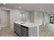 Kitchen island with white quartz countertop and stainless steel dishwasher at 6161 Timberdale Ave, Wesley Chapel, FL 33545