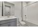 Bathroom with gray vanity, tub, and shower at 6161 Timberdale Ave, Wesley Chapel, FL 33545