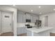 Modern kitchen with gray cabinets, quartz countertops and stainless steel appliances at 6161 Timberdale Ave, Wesley Chapel, FL 33545