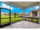 Enjoy Florida living in this screened patio, overlooking a backyard and neighboring homes at 6161 Timberdale Ave, Wesley Chapel, FL 33545