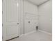 Laundry room with overhead shelving and door at 6161 Timberdale Ave, Wesley Chapel, FL 33545