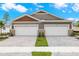 Two-story home with a double garage and landscaped yard at 6161 Timberdale Ave, Wesley Chapel, FL 33545