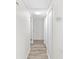 Clean hallway with wood-look floors and built-in closets at 209 Dogwood Dr, Brooksville, FL 34601