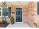 Dark-colored front door with brick facade and landscaping at 209 Dogwood Dr, Brooksville, FL 34601