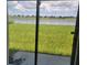 Sliding glass doors reveal a scenic lake view from the backyard at 14443 Touch Gold Ln, Sun City Center, FL 33573