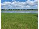 Peaceful lakefront property with lush green grass at 14443 Touch Gold Ln, Sun City Center, FL 33573