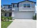 Two-story house with gray siding, dark brown accents, and a two car garage at 14443 Touch Gold Ln, Sun City Center, FL 33573