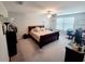 Main bedroom with a king-size bed and an office area at 14443 Touch Gold Ln, Sun City Center, FL 33573