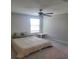 Spacious bedroom with a queen bed and ceiling fan at 14443 Touch Gold Ln, Sun City Center, FL 33573