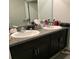 Double vanity bathroom with granite countertops at 14443 Touch Gold Ln, Sun City Center, FL 33573
