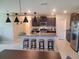 Modern kitchen with granite countertops, island, and stainless steel appliances at 14443 Touch Gold Ln, Sun City Center, FL 33573
