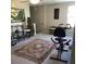 Bright bonus room with exercise equipment and decorative rug at 14443 Touch Gold Ln, Sun City Center, FL 33573