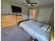 Bright bedroom with double bed, dresser, and ceiling fan at 14443 Touch Gold Ln, Sun City Center, FL 33573