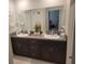 Double vanity bathroom with dark brown cabinets at 14443 Touch Gold Ln, Sun City Center, FL 33573