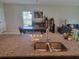 Kitchen with granite countertops and a double sink overlooking the dining area at 14443 Touch Gold Ln, Sun City Center, FL 33573