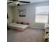Small bedroom with twin bed, decorative wall hanging, and window blinds at 14443 Touch Gold Ln, Sun City Center, FL 33573