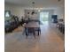Open dining room with a large table and chairs, and view to the kitchen at 14443 Touch Gold Ln, Sun City Center, FL 33573