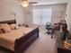 Main bedroom with a king-size bed and an office area at 14443 Touch Gold Ln, Sun City Center, FL 33573