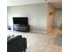 Bright living room with tile floors and a large TV at 14443 Touch Gold Ln, Sun City Center, FL 33573