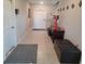 Bright and spacious entryway with tile flooring and a storage bench at 14443 Touch Gold Ln, Sun City Center, FL 33573