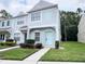 Two-story townhome with light-blue front door and well-maintained landscaping at 8628 Hunters Key Cir, Tampa, FL 33647