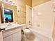 Clean bathroom with a shower/tub combo and glass shelves at 8628 Hunters Key Cir, Tampa, FL 33647