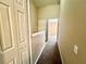 Upstairs hallway with carpet and access to bedrooms at 8628 Hunters Key Cir, Tampa, FL 33647