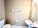 Simple half bathroom with a toilet and pedestal sink at 8628 Hunters Key Cir, Tampa, FL 33647