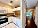 Galley-style kitchen with granite counters and a view into the living area at 8628 Hunters Key Cir, Tampa, FL 33647