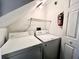 Stacked washer and dryer in a compact laundry room with shelving at 8628 Hunters Key Cir, Tampa, FL 33647