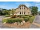 Two-story yellow house with landscaping and brick walkway at 201 Elm View Ct, Brandon, FL 33511