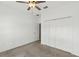 Spacious bedroom with neutral walls, ceiling fan and double door closet at 30351 Marquette Ave, Wesley Chapel, FL 33545