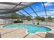 Refreshing pool with screened enclosure at 9506 Pebble Glen Ave, Tampa, FL 33647