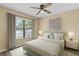 Serene bedroom with light-green bed and large window at 9506 Pebble Glen Ave, Tampa, FL 33647