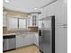 Modern kitchen featuring stainless steel appliances and white cabinetry at 9506 Pebble Glen Ave, Tampa, FL 33647