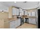 Open kitchen boasting granite countertops and white cabinets at 9506 Pebble Glen Ave, Tampa, FL 33647
