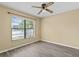 Simple bedroom with wood-look flooring and large window at 9506 Pebble Glen Ave, Tampa, FL 33647