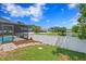 Landscaped backyard with pool and lake view at 9506 Pebble Glen Ave, Tampa, FL 33647