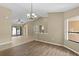 Bright dining room with hardwood floors and a chandelier at 9506 Pebble Glen Ave, Tampa, FL 33647