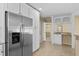 Kitchen with stainless steel refrigerator and white cabinets at 9506 Pebble Glen Ave, Tampa, FL 33647
