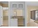 Convenient wet bar with granite countertop and white cabinets at 9506 Pebble Glen Ave, Tampa, FL 33647