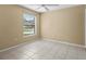 Bright bedroom with tile flooring and large window at 9506 Pebble Glen Ave, Tampa, FL 33647