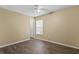 Spacious bedroom with wood-look flooring and large window at 9506 Pebble Glen Ave, Tampa, FL 33647