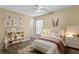 Cozy bedroom with a white bed, bookcase, and whimsical wall art at 9506 Pebble Glen Ave, Tampa, FL 33647