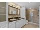 Elegant bathroom with double vanity, granite countertops, and a large shower at 9506 Pebble Glen Ave, Tampa, FL 33647