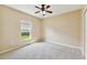 Spacious bedroom with neutral wall-to-wall carpeting and a ceiling fan at 5321 Silver Charm Ter, Wesley Chapel, FL 33544