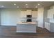 Bright kitchen with a large island, stainless steel appliances, and white cabinets, ready for cooking at 16029 7Th E Ave, Bradenton, FL 34212