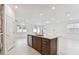 Modern kitchen island with stainless steel dishwasher in a well-lit, open space at 20783 Balsam Hill Rd, Land O Lakes, FL 34638