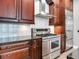 Kitchen with stainless steel range, granite countertops, and dark wood cabinets at 2501 N Dundee St, Tampa, FL 33629
